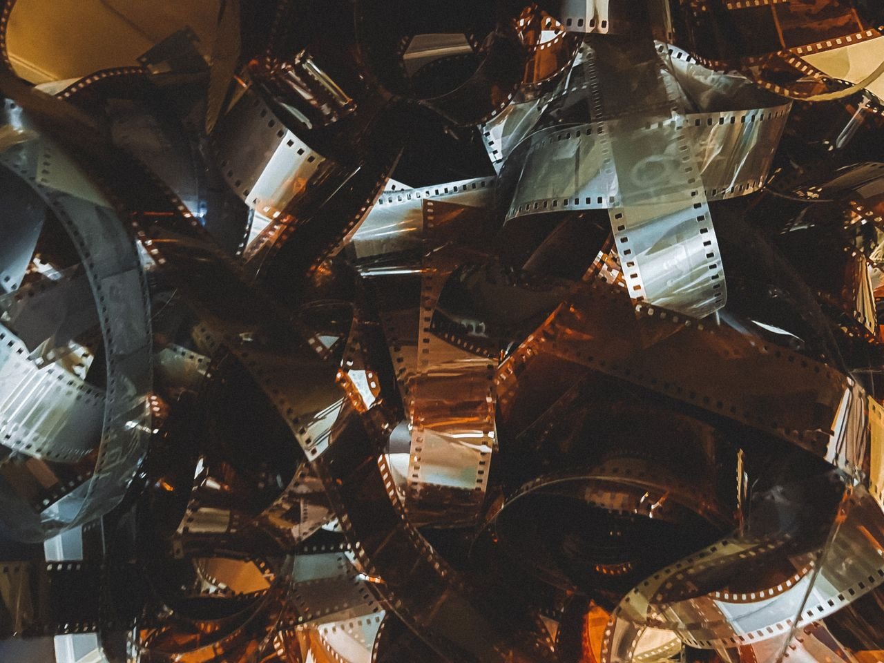 A collection of tangled old-fashioned camera film strips with a retro feel.