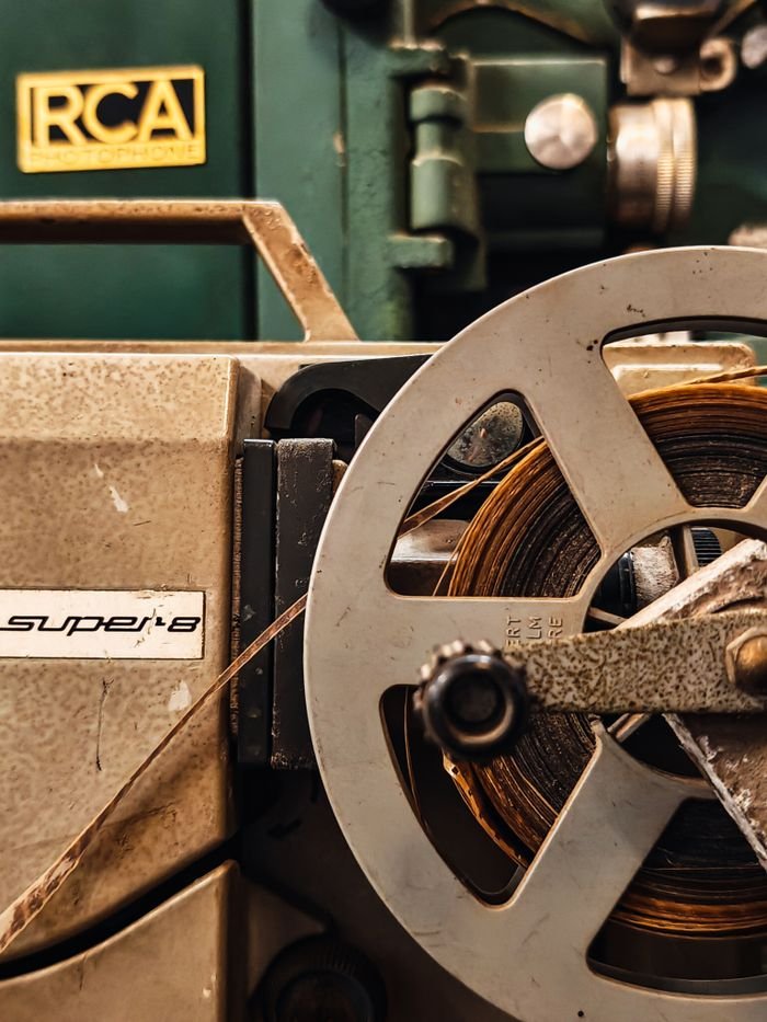 pexels-photo-35082512 Detailed view of a vintage Super 8 film projector, showcasing its mechanical components and classic design.