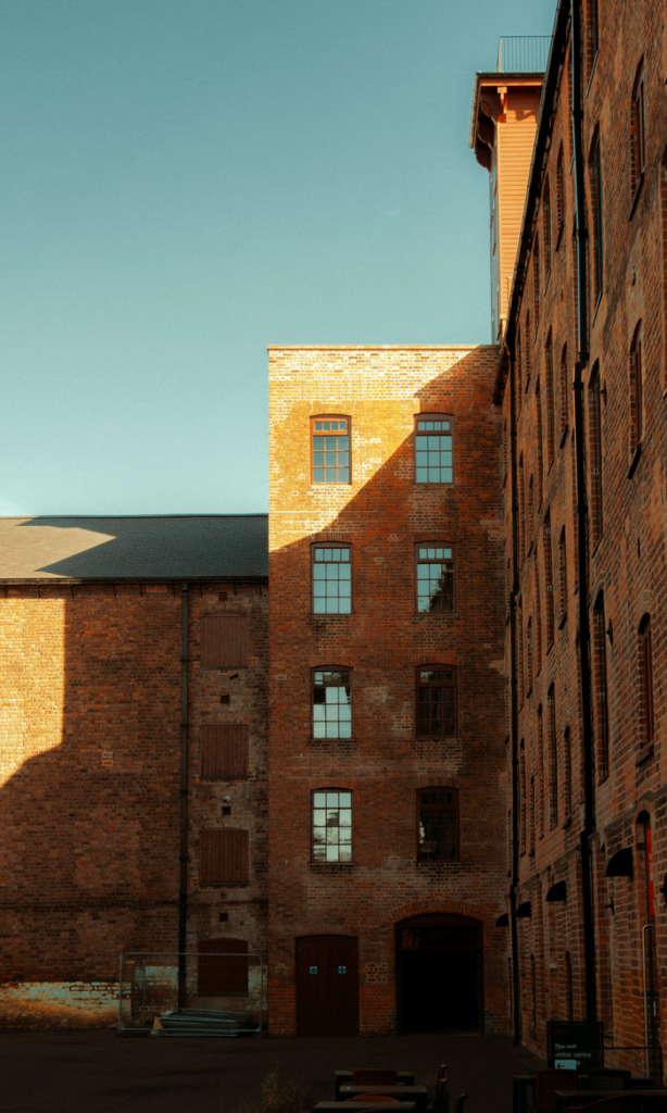 pexels-photo-36684100 View of a historic industrial brick building in Shrewsbury, England, under clear skies.