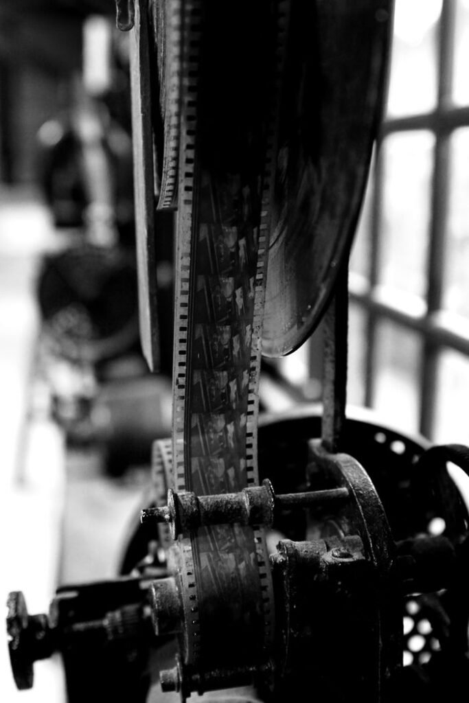 pexels-photo-9744138 Close-up of an antique film projector showcasing film reels in monochrome.